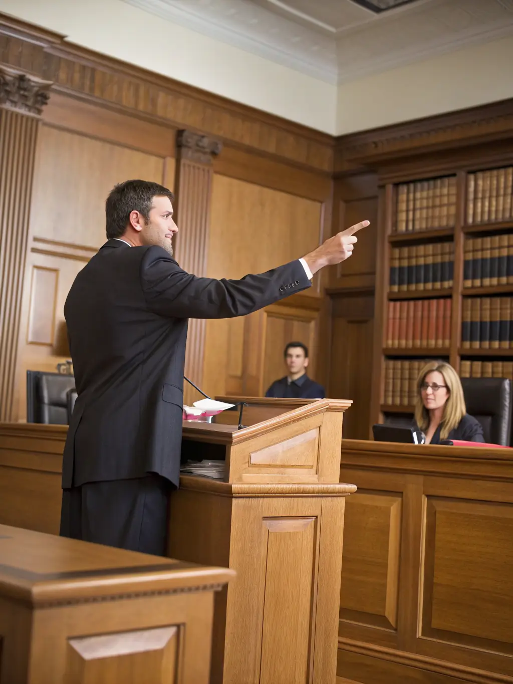 A courtroom scene with a defense attorney presenting a case to a judge, advocating for their client's rights and ensuring a fair trial.